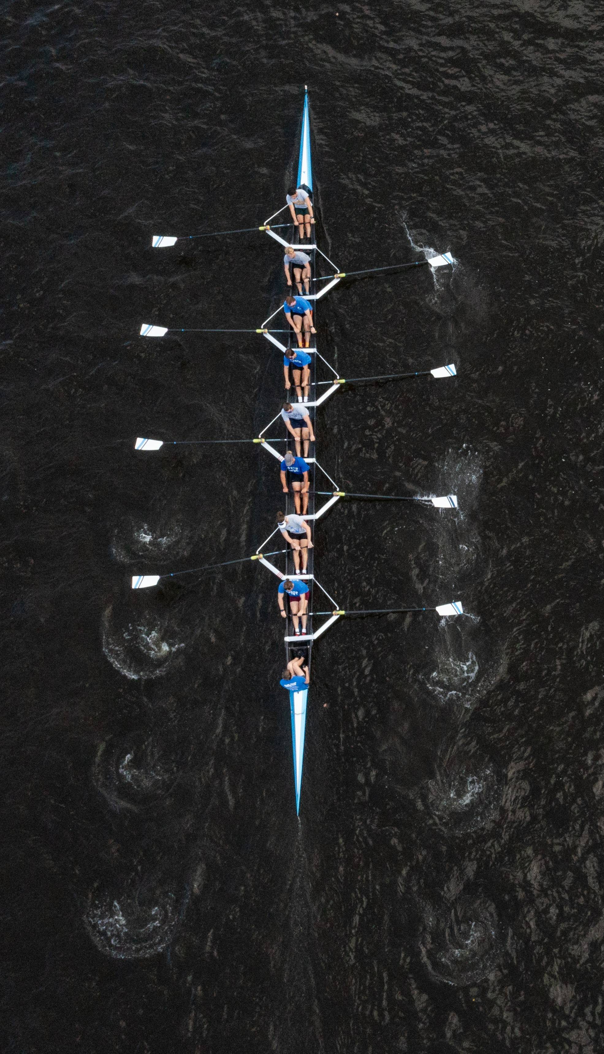 Aerial shot of the rowing team with an eight man boat practicing on the Grand River